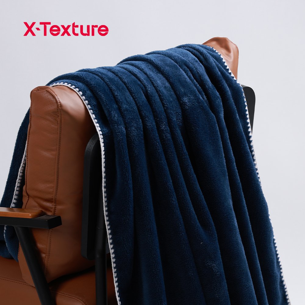 Navy blue soft and warm double side fleece fabric draped over a chair.
