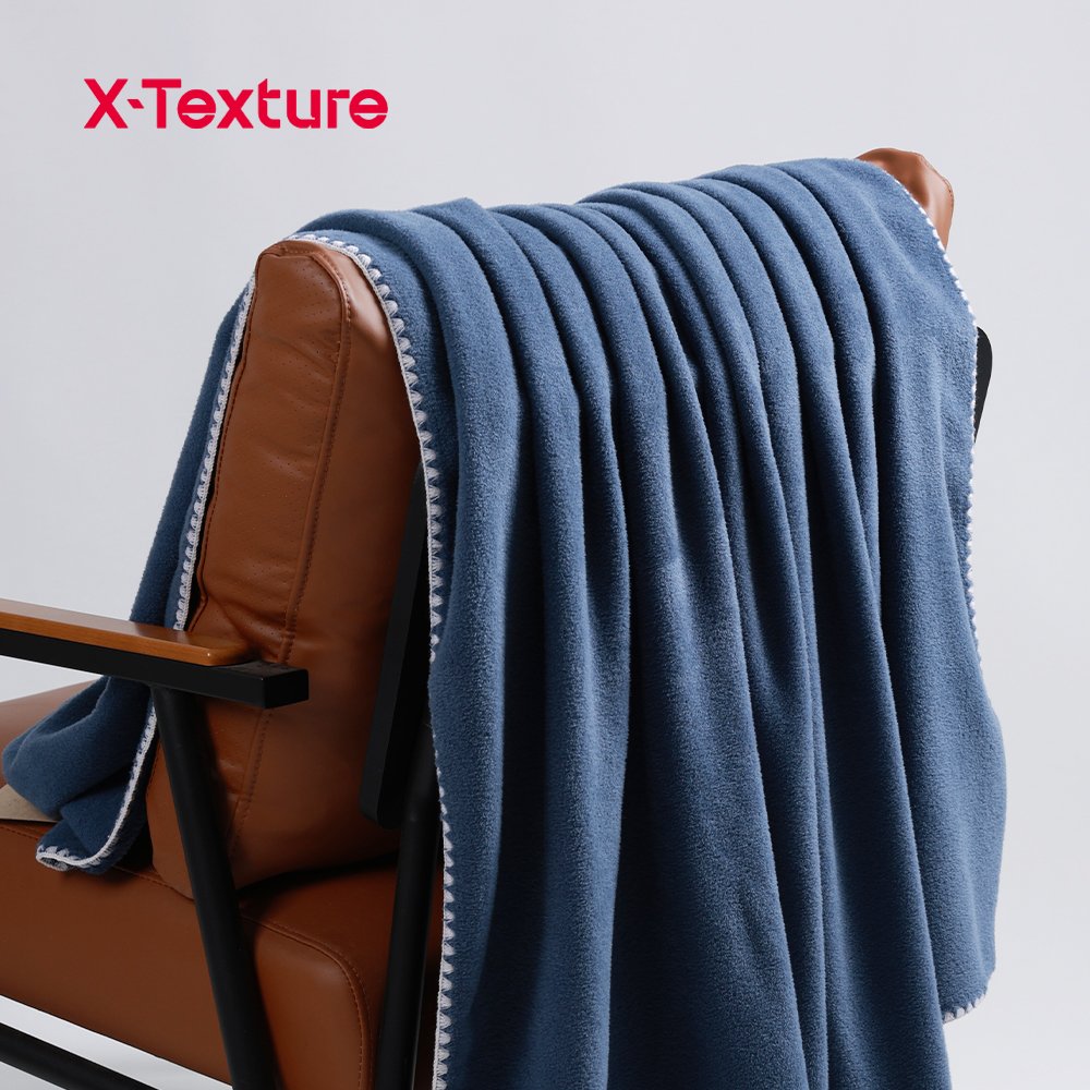 Slate blue soft and warm double side fleece fabric draped over a chair.