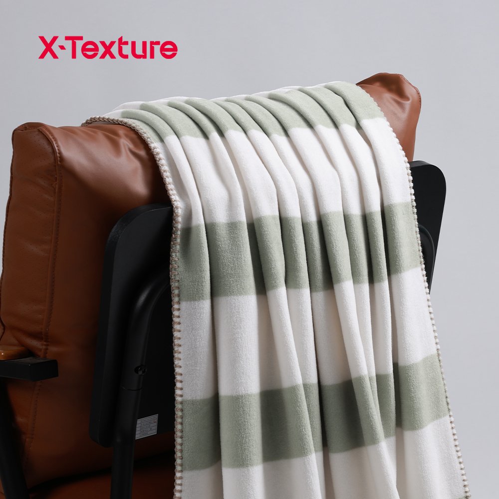 Sage green plaid print soft and warm double side fleece fabric draped over a chair.