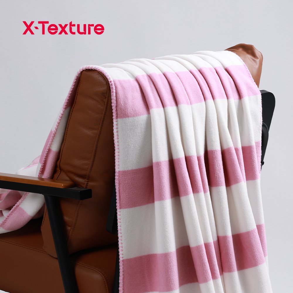 Pink large check print soft and warm double side fleece fabric draped over a chair.