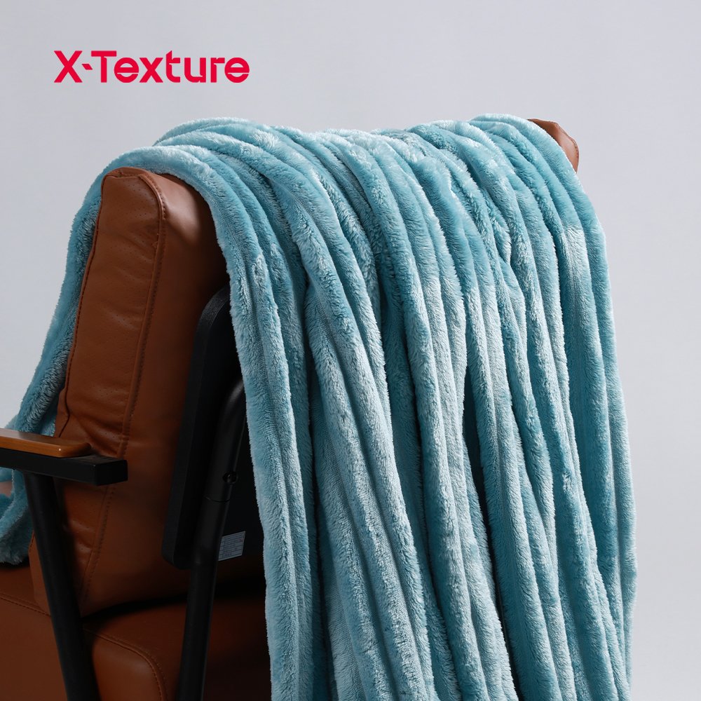 Sky blue soft and warm coral fleece fabric draped over a chair.
