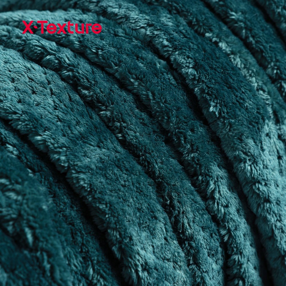 Close-up of dark green embossed coral fleece fabric with a dense plush surface.