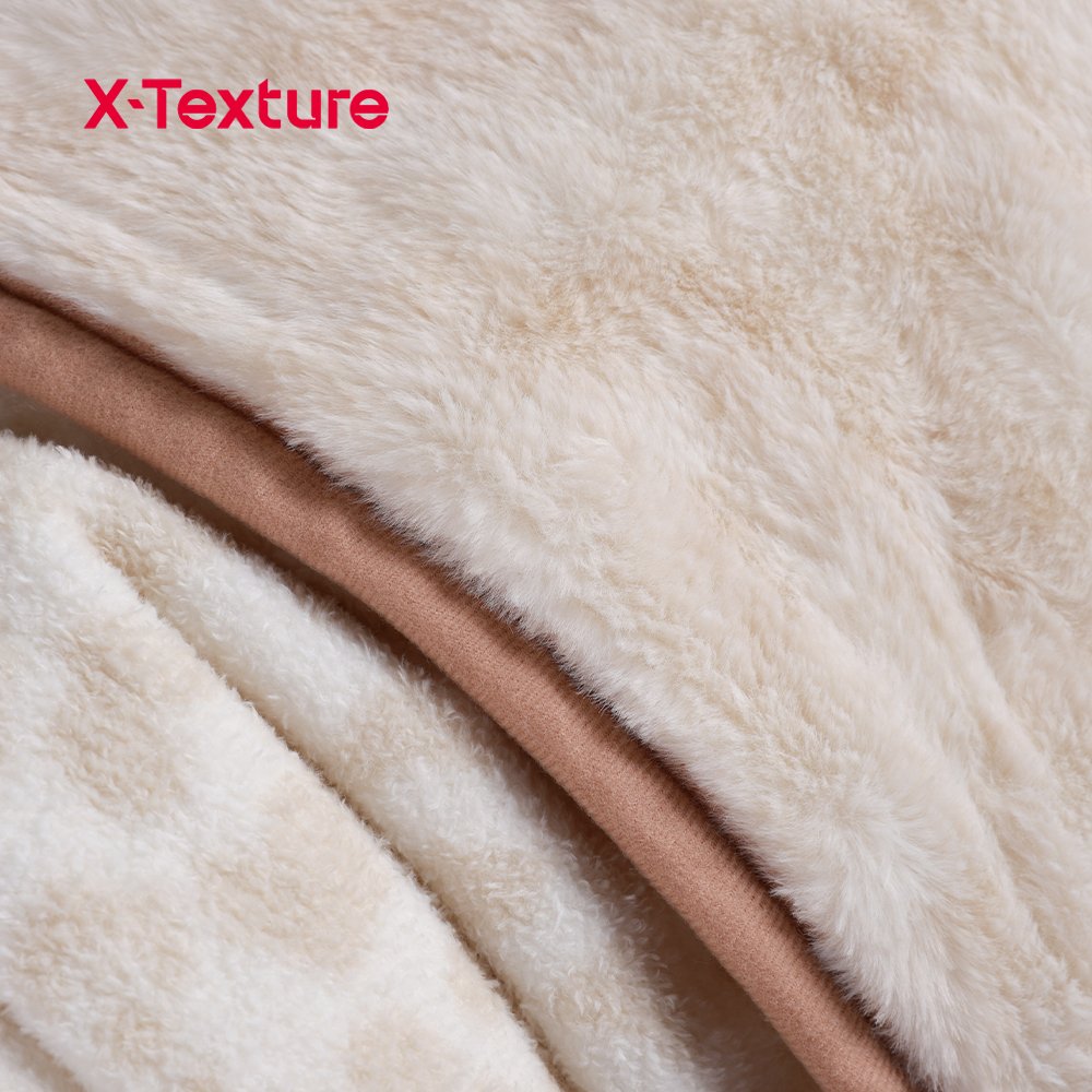 Close-up of cream white faux fur fabric with a soft plush pile.