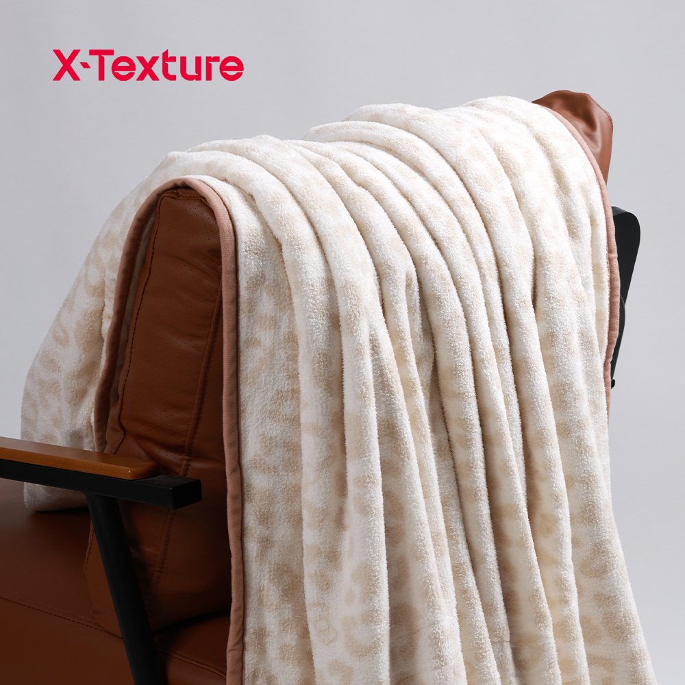 Cream white soft faux fur fabric draped over a chair.