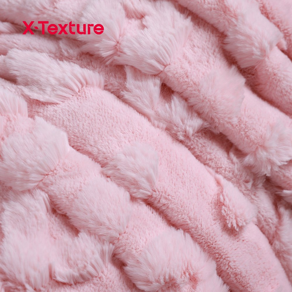 Close-up of light pink striped embossed coral fleece fabric with a plush surface.
