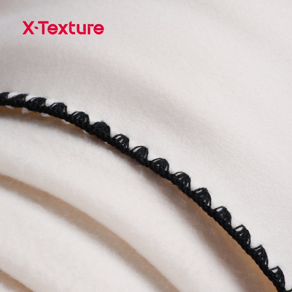 Close-up of cream white double side fleece fabric with a soft plush surface.