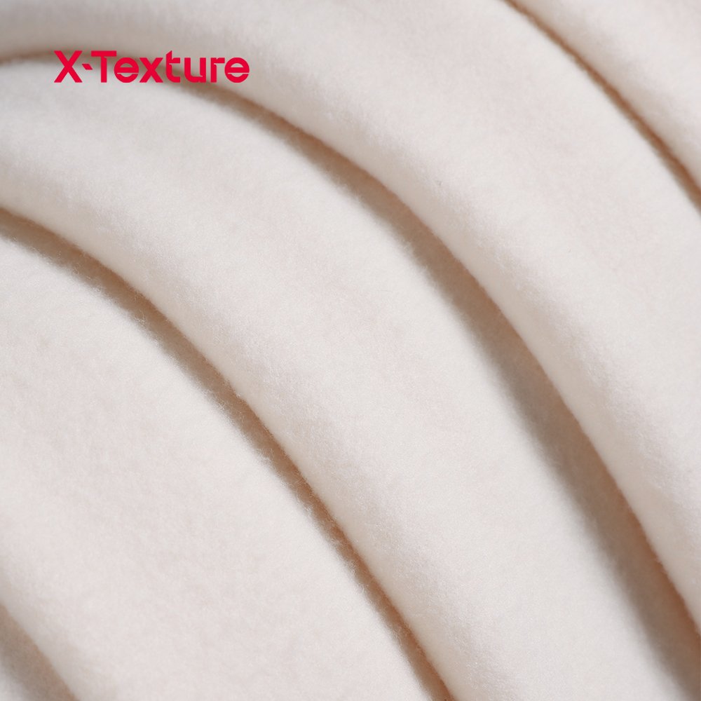 Cream white double side fleece fabric showing the contrasting black binding detail.