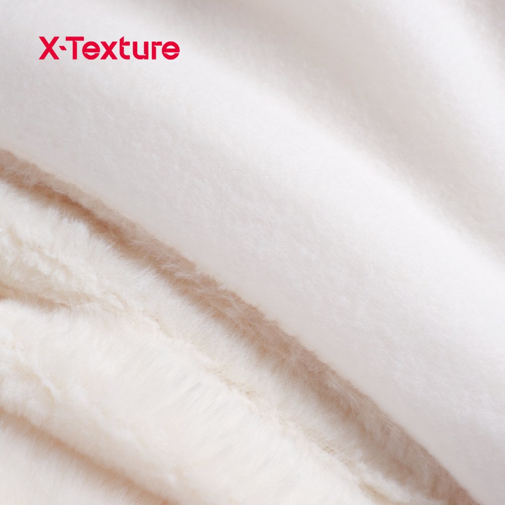 Close-up of cream white long pile faux fur fabric with a soft plush surface.