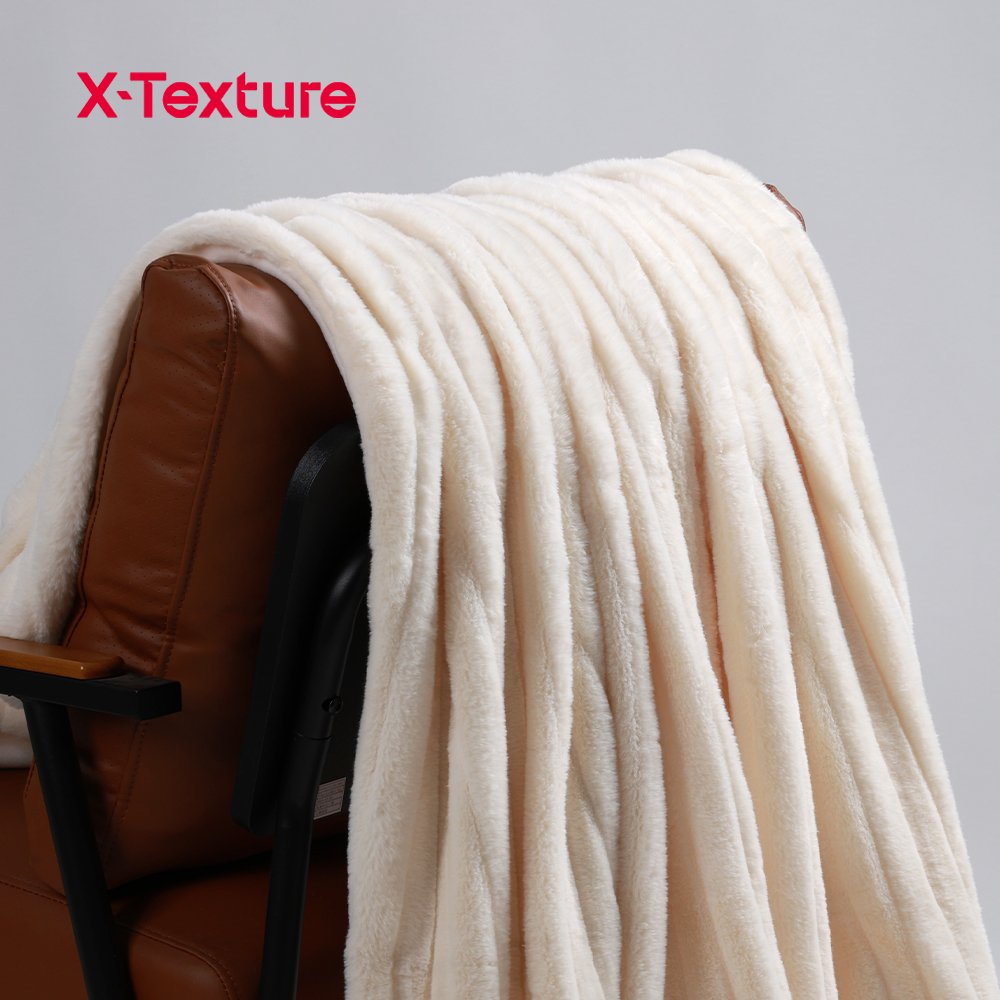 Cream white long pile faux fur fabric draped over a chair.