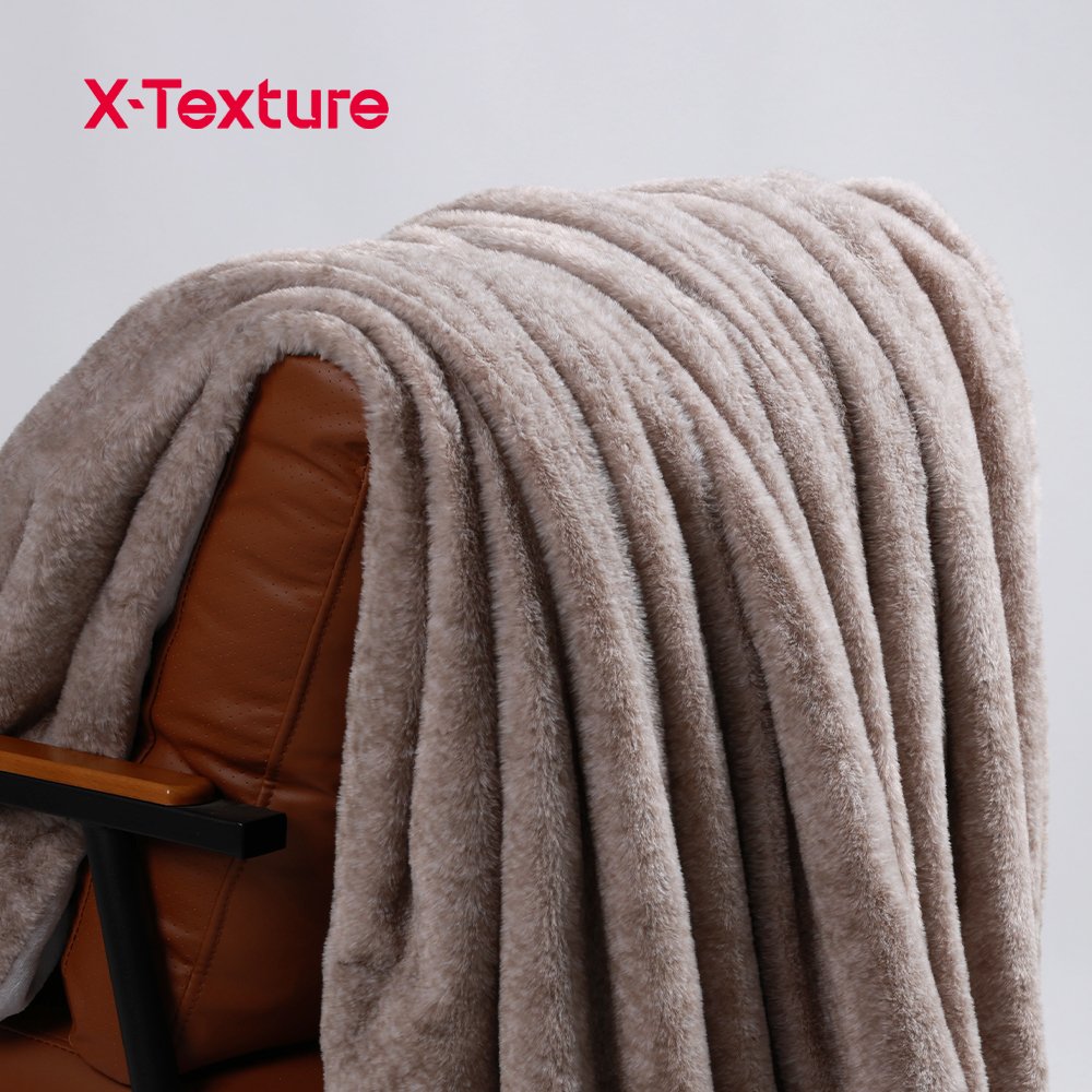 Taupe rabbit-feel faux fur fabric draped over a chair.