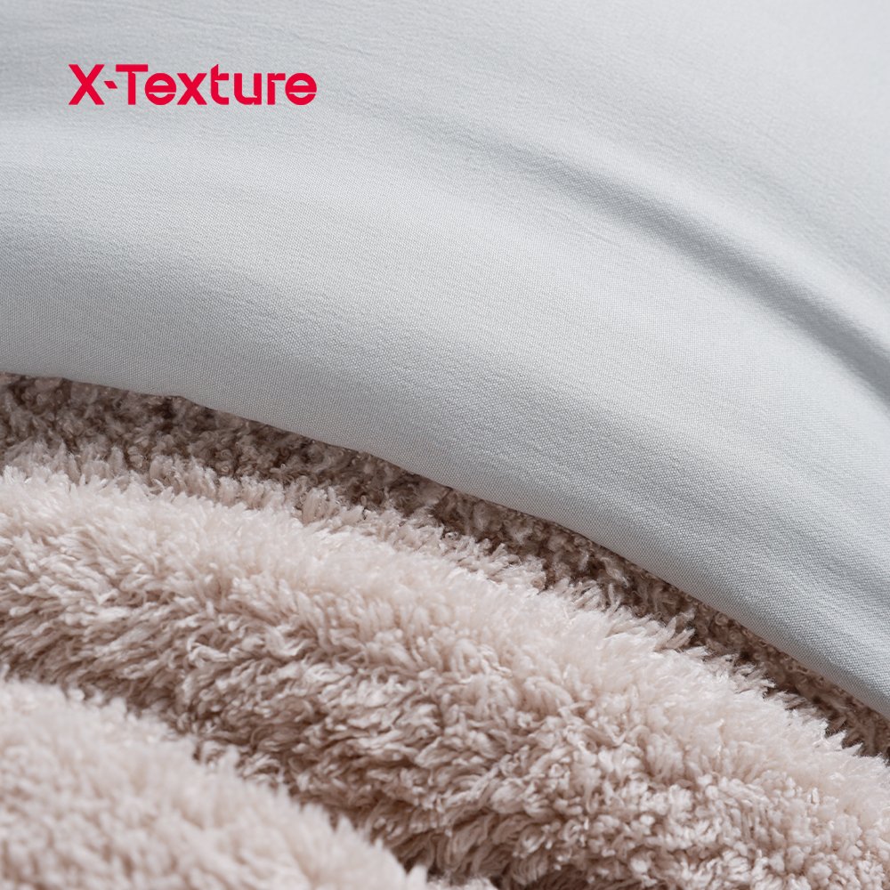 Close-up of taupe teddy fleece blanket with a soft curly plush surface.
